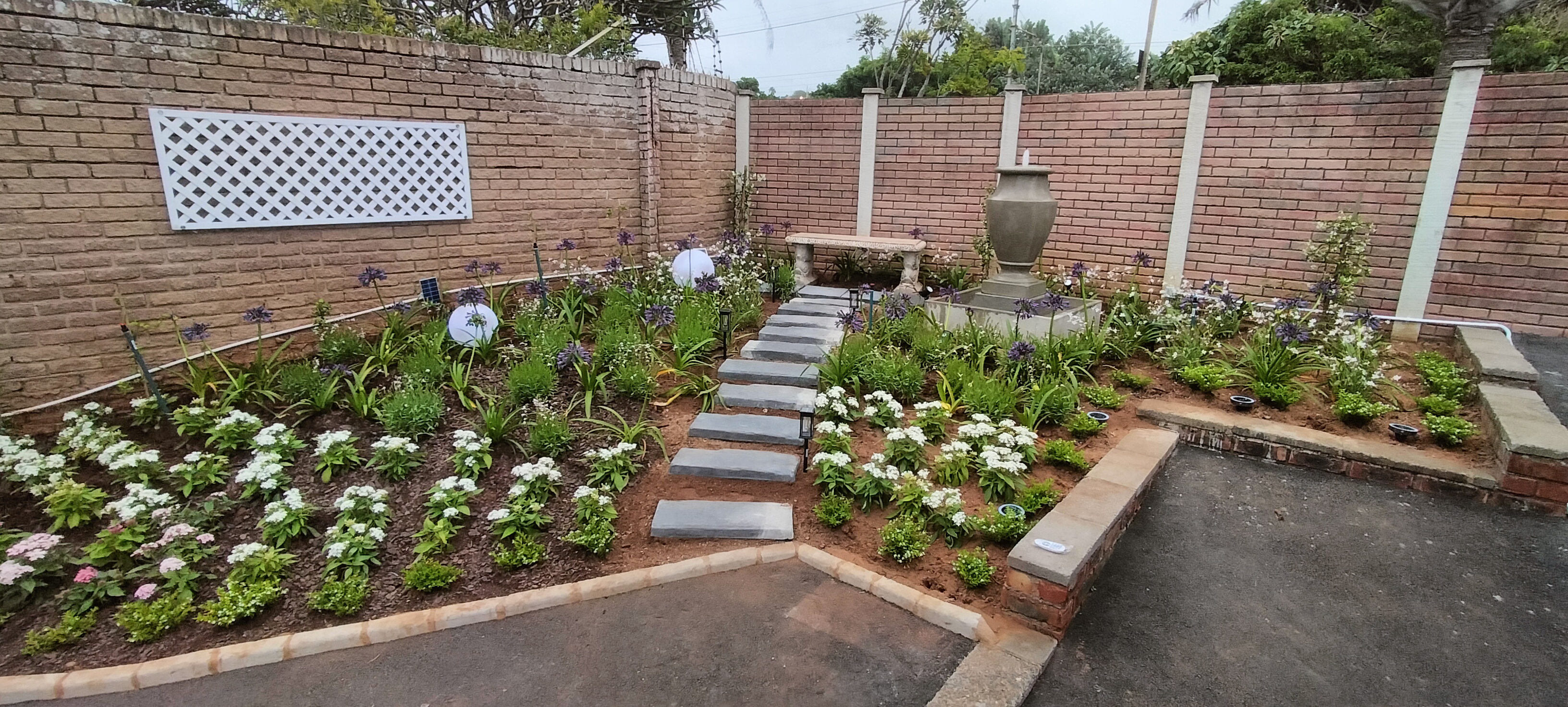 Neatly maintained garden beds and paved areas